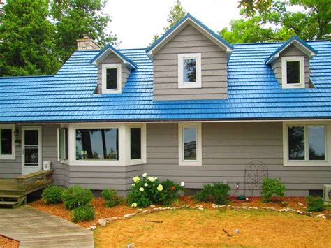 blue house with grey metal roof|houses with blue shingle roofs.